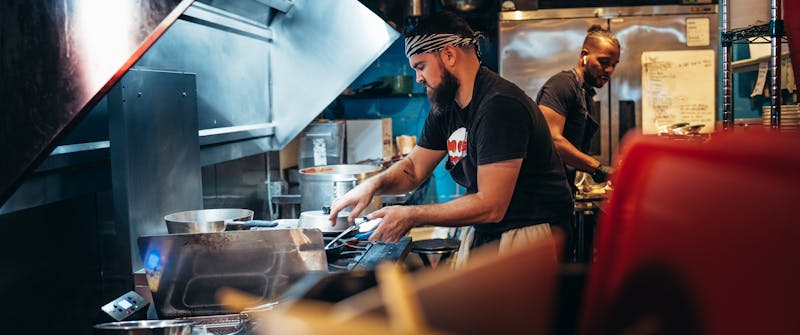 Giordanos kitchen team preparing fresh pizzas and pasta dishes